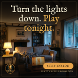 A living room with the lights turned down, laptop glowing and a candle lit: 